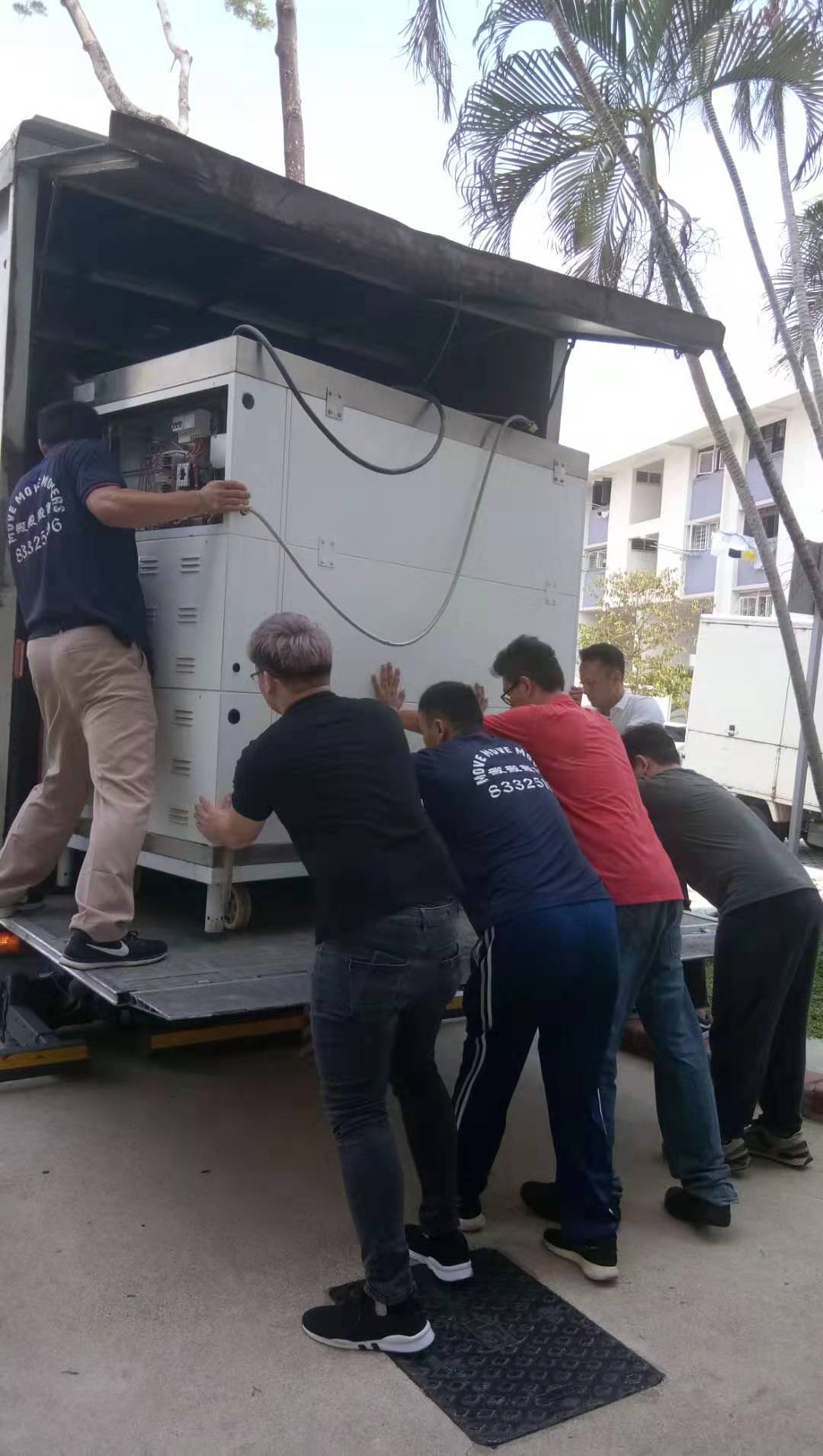 Heavy equipment tailgate loading - move move movers – move move movers – move move movers Move Move Movers crew pushing heavy commercial equipment onto a moving truck tailgate