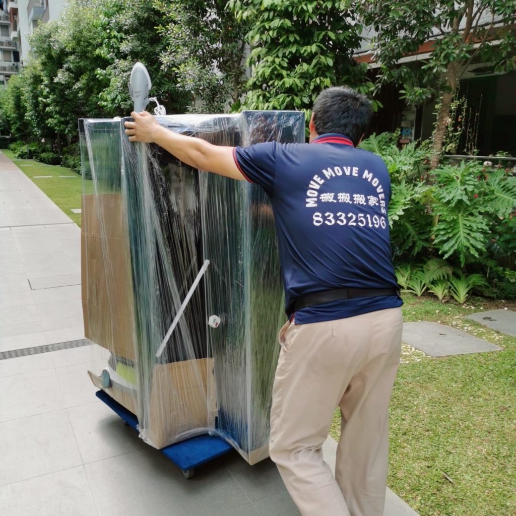 Move Move Movers crew protecting and moving an upright piano in a Singapore HDB estate