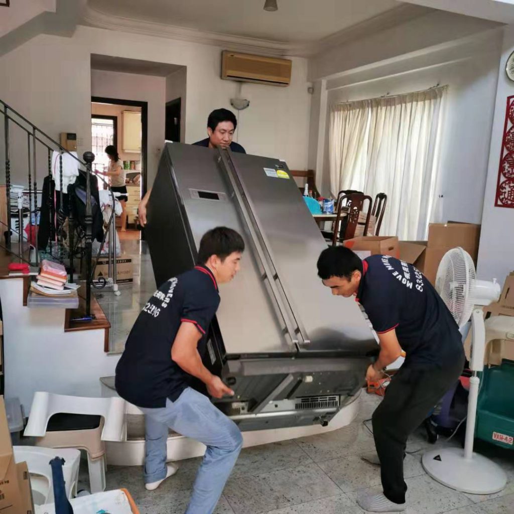 Move Move Movers crew carrying a double-door fridge through a narrow Singapore home route