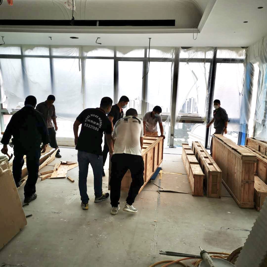 Move Move Movers crew handling crated commercial goods during a last-mile business delivery