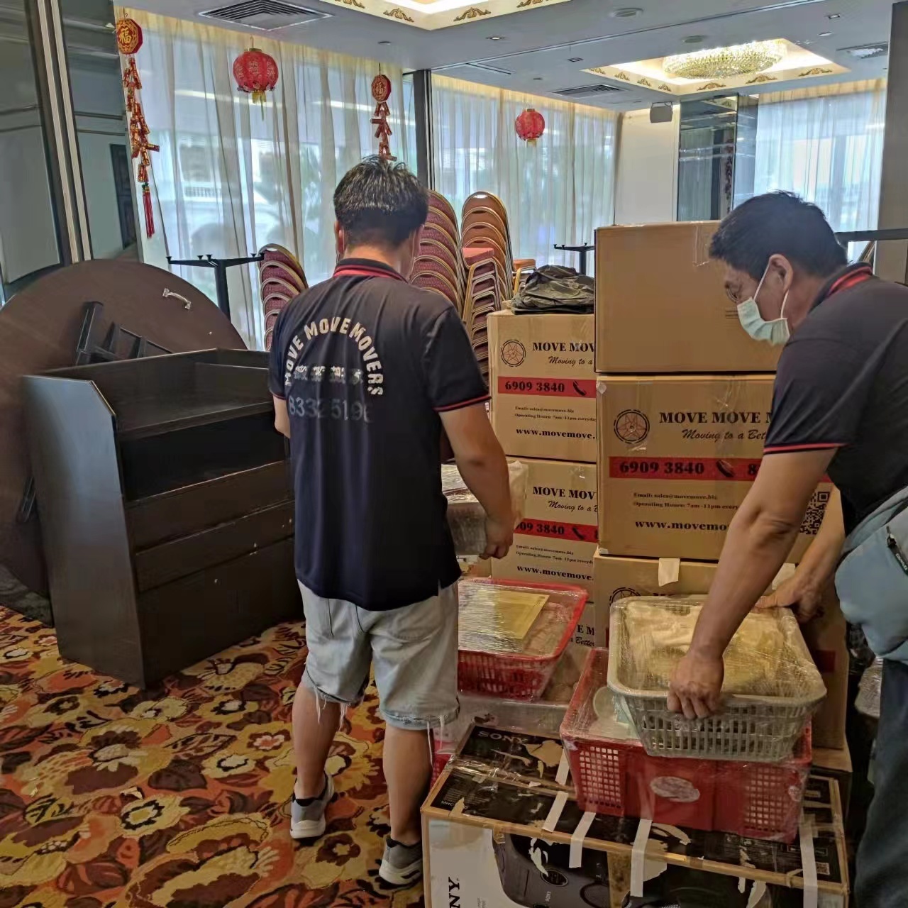 Move Move Movers crew handling packed cartons and protected items indoors