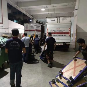 Office disposal team loading items after hours in a Singapore basement dock