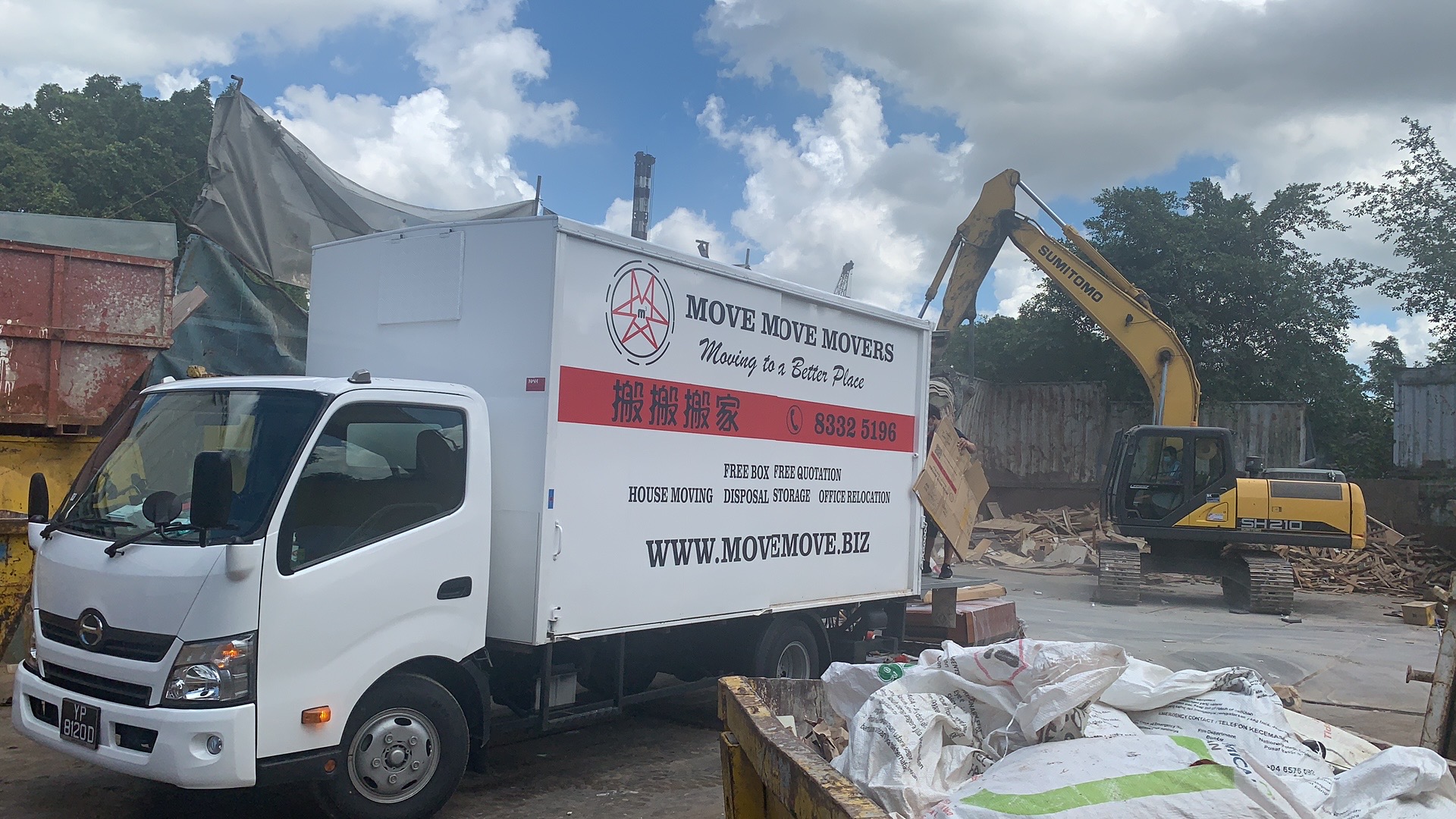 Move Move Movers truck staged at a debris-heavy junk-removal site in Singapore