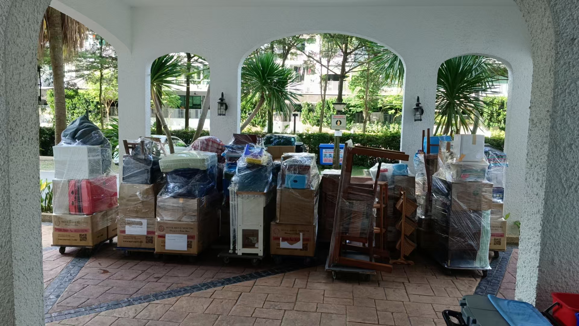 Household items staged on trolleys before a larger residential clearance in Singapore