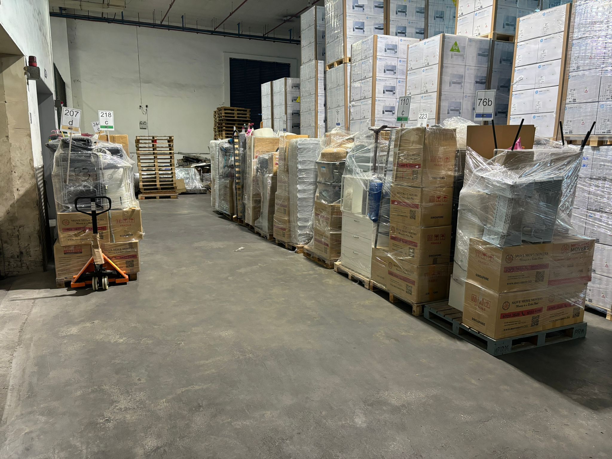 Wrapped pallet storage in warehouse – move move movers – move move movers Wrapped furniture and household items stored on pallets during a Singapore renovation storage move
