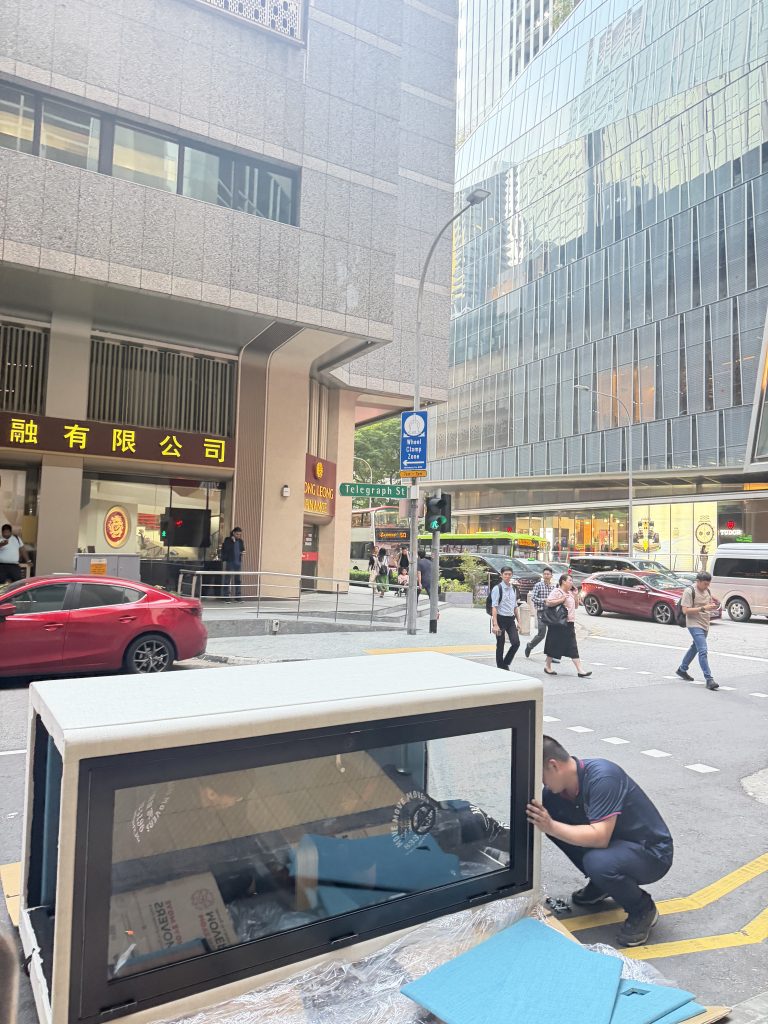 Move Move Movers crew handling wrapped furniture during a Singapore move